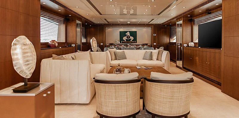 a room with a couch and a television aboard BEYOND Yacht for Charter