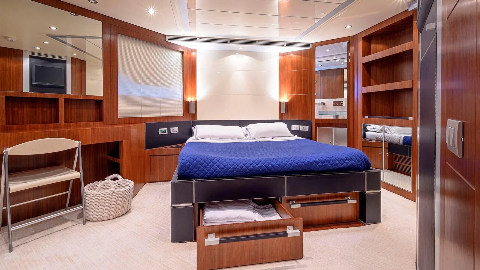 a room with a bed and a tv aboard BEYOND Yacht for Charter