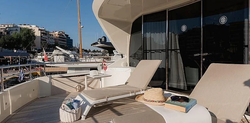 a lounge chair on a deck aboard BEYOND Yacht for Charter