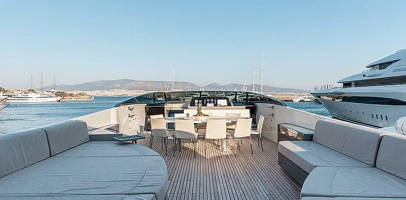 a deck with chairs and tables on it aboard BEYOND Yacht for Charter