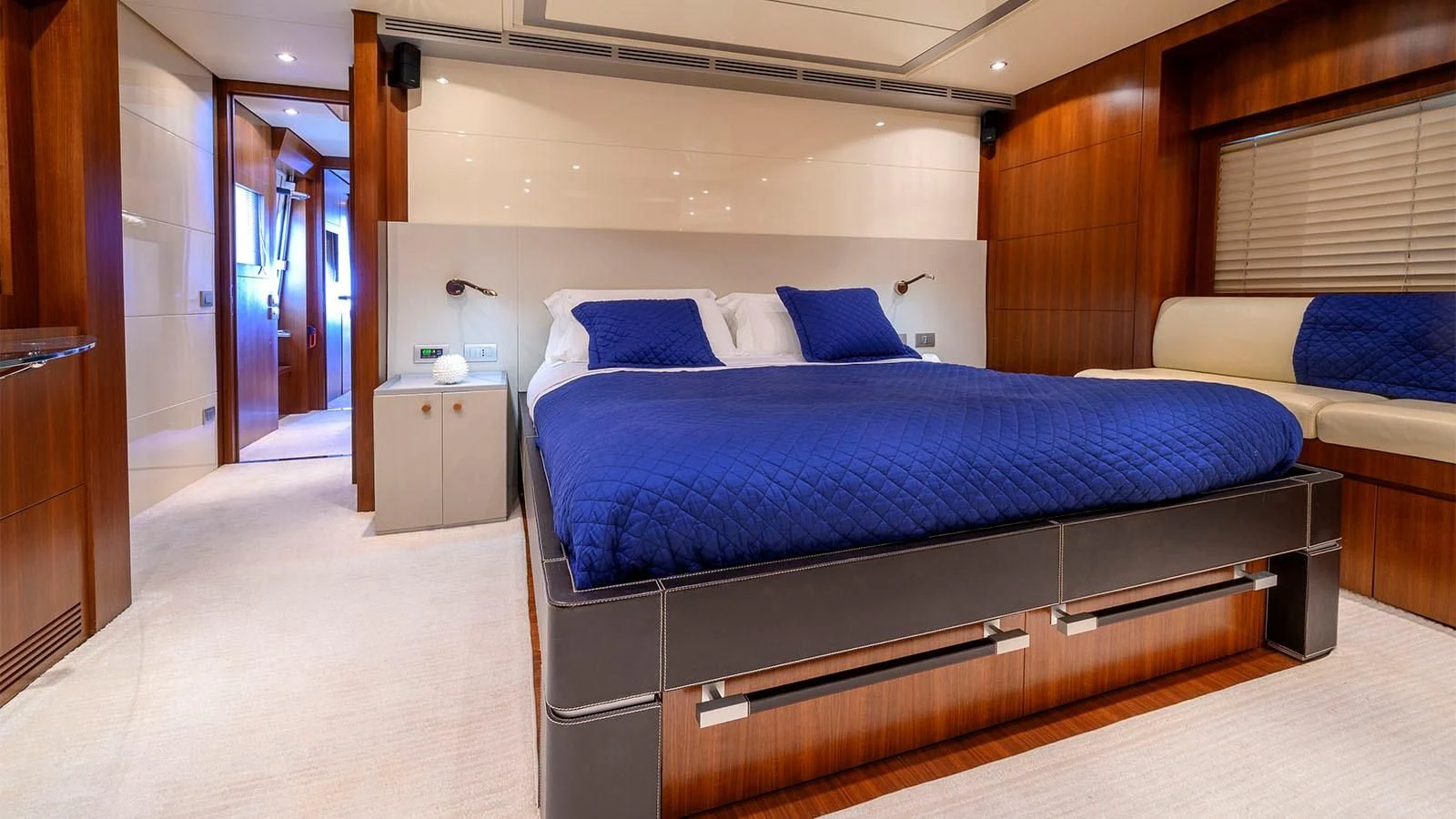 a room with a bed and a desk aboard BEYOND Yacht for Charter