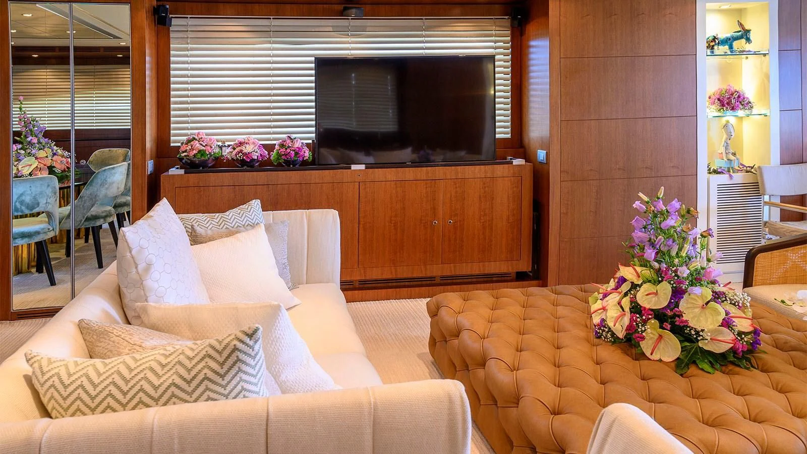 a living room with couches and a tv aboard BEYOND Yacht for Charter
