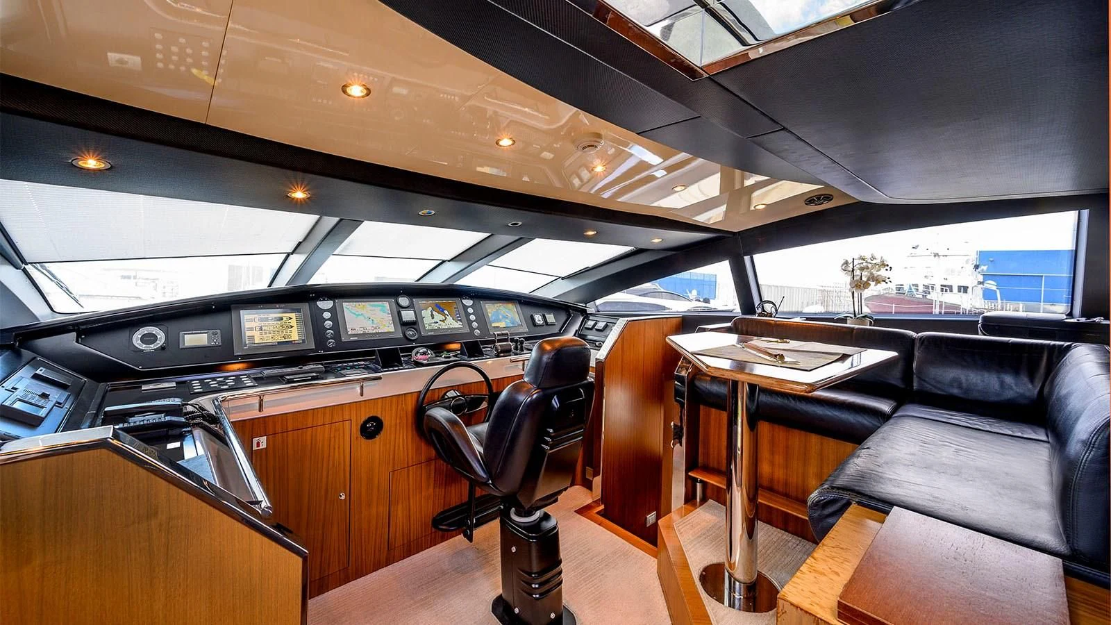 a room with a desk and chairs aboard BEYOND Yacht for Charter