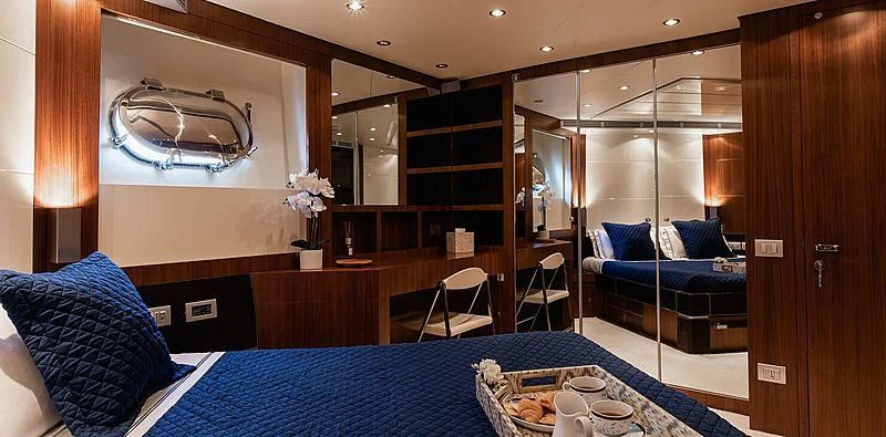 a room with a bed and a couch aboard BEYOND Yacht for Charter