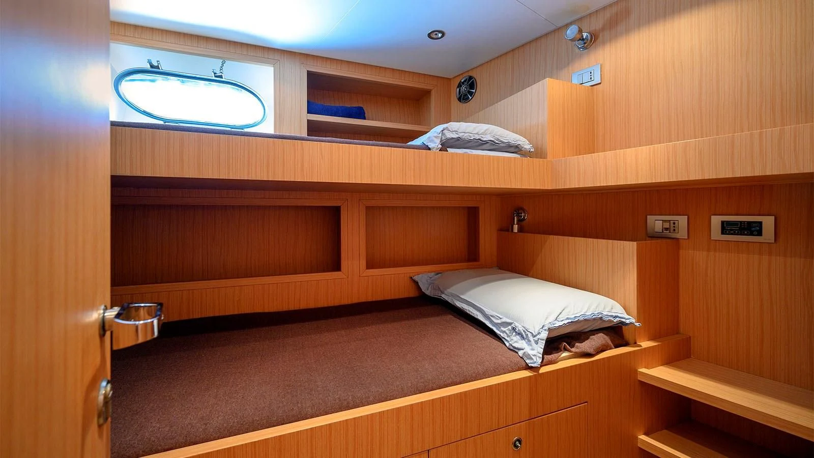 a room with wooden cabinets aboard BEYOND Yacht for Charter