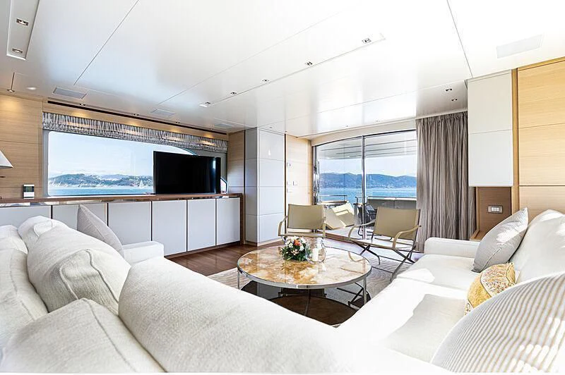 a living room with a large flat screen tv and a table aboard THE UNIFIER KING ABDULAZIZ THE FIRST Yacht for Sale