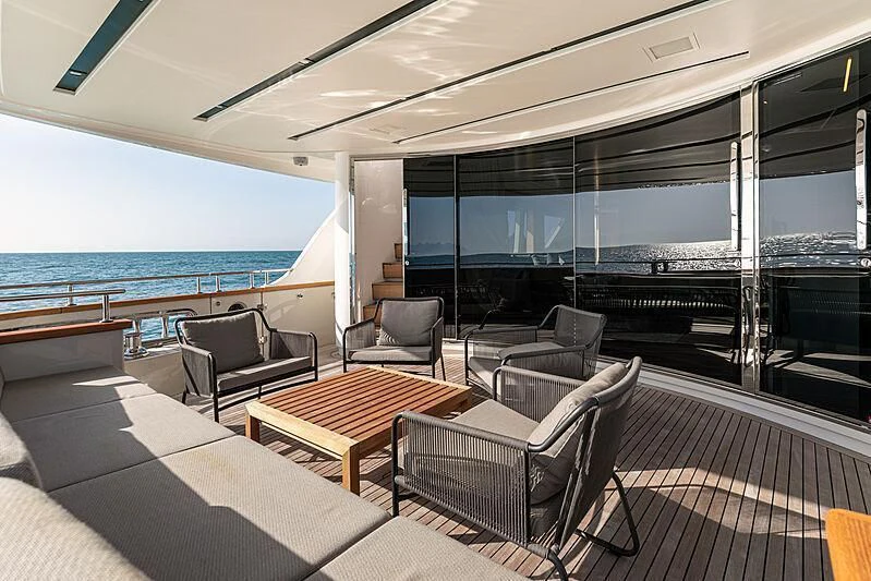 a room with a table chairs and a large window overlooking the ocean aboard THE UNIFIER KING ABDULAZIZ THE FIRST Yacht for Sale