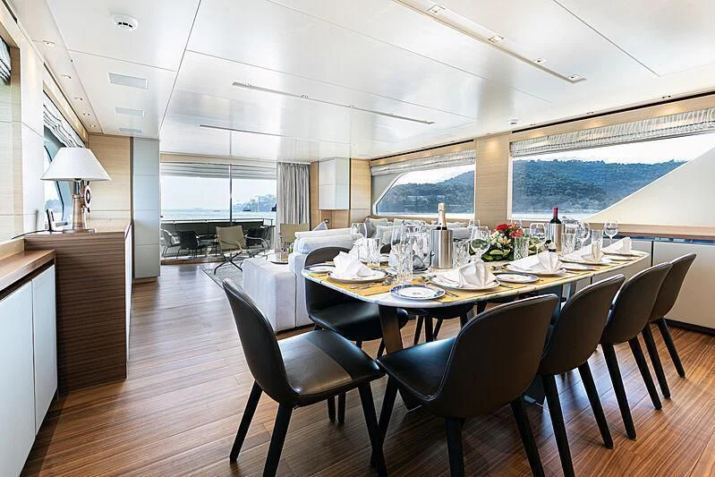 a dining table with a large window aboard THE UNIFIER KING ABDULAZIZ THE FIRST Yacht for Sale