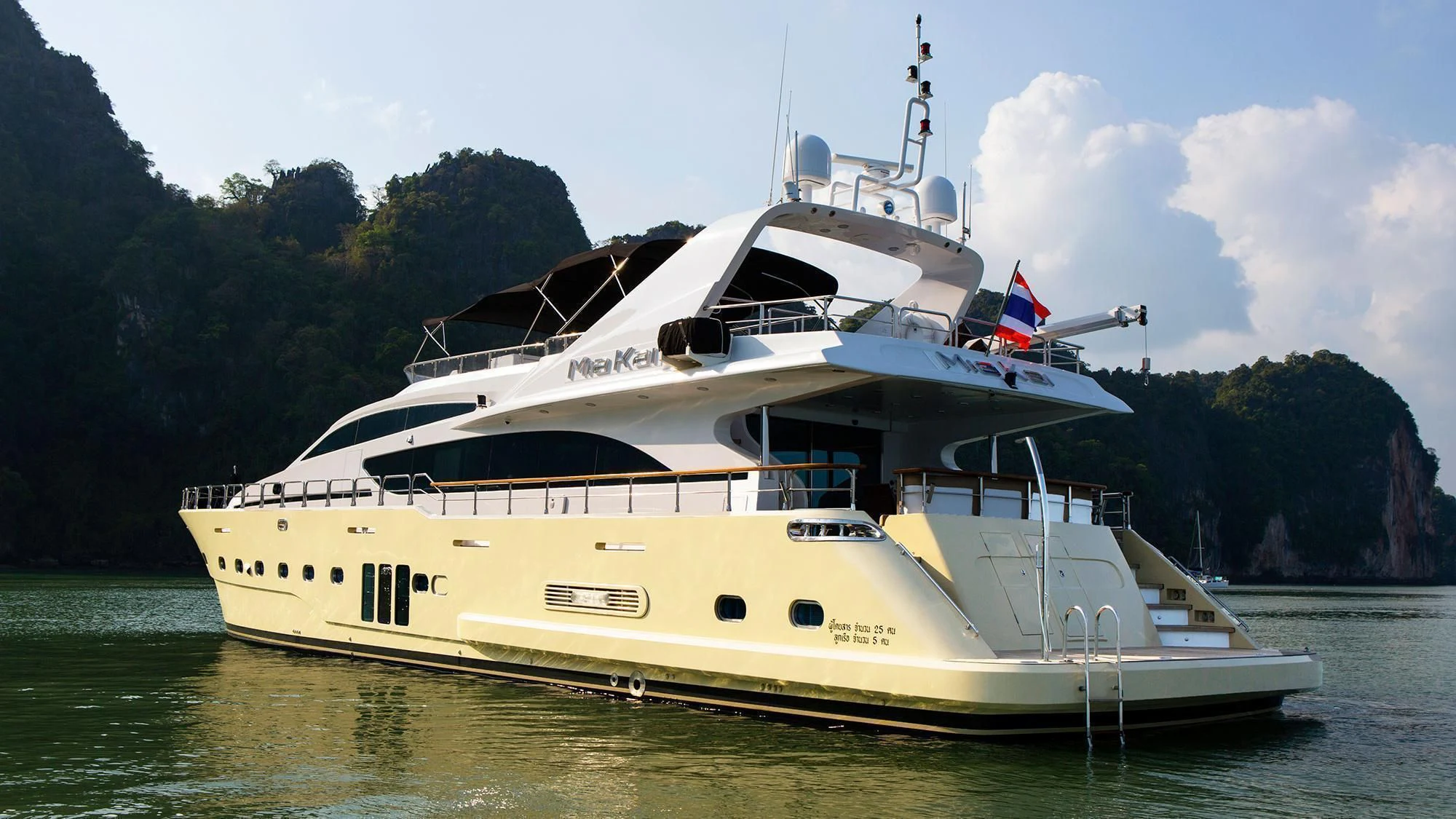 a large white boat on a river aboard MIA KAI Yacht for Charter