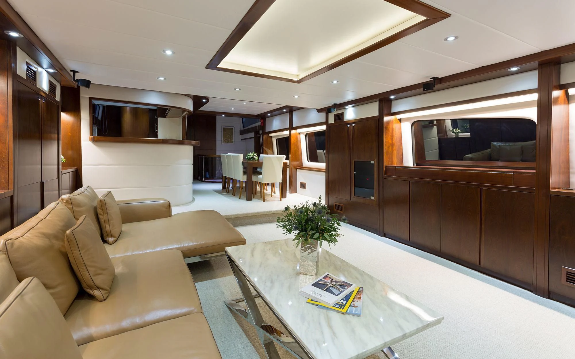 a living room with a couch and coffee table aboard MIA KAI Yacht for Charter
