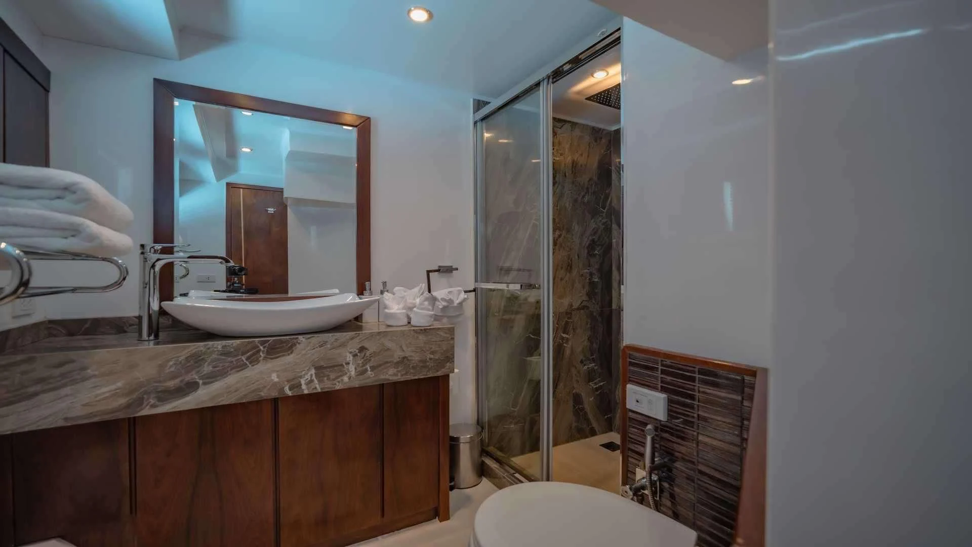 a bathroom with a large mirror aboard MIA KAI Yacht for Charter