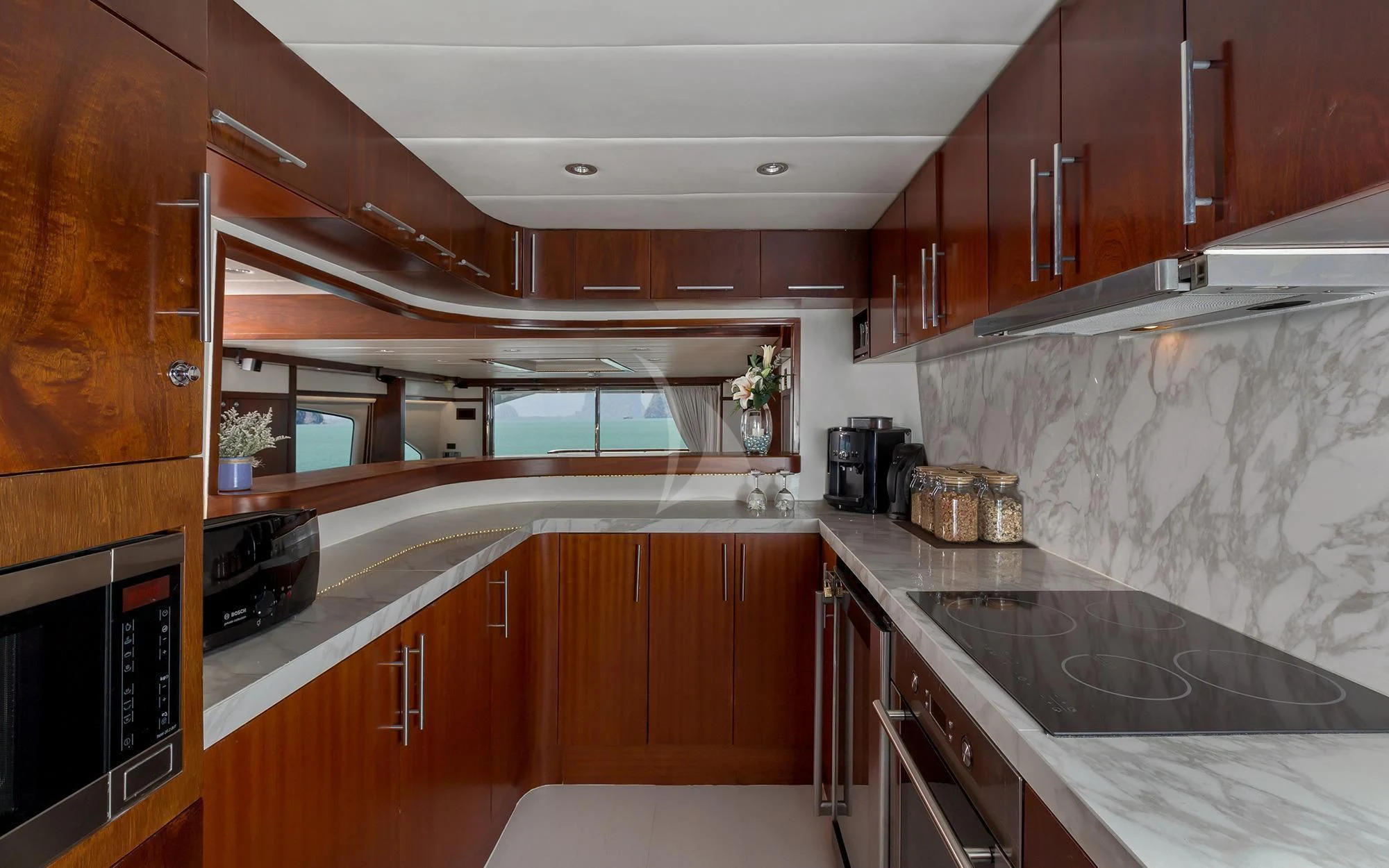 a kitchen with wooden cabinets aboard MIA KAI Yacht for Charter