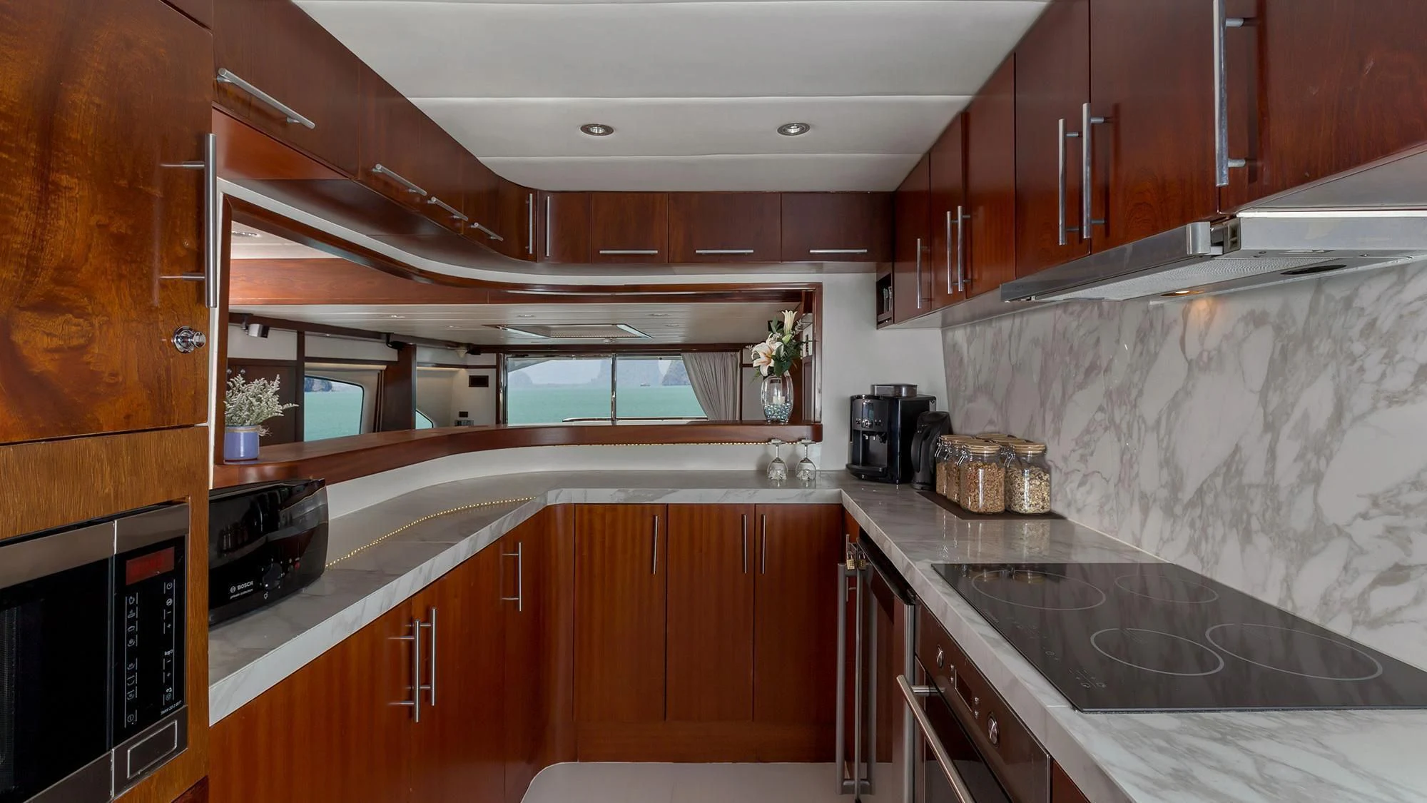 a kitchen with wooden cabinets aboard MIA KAI Yacht for Charter