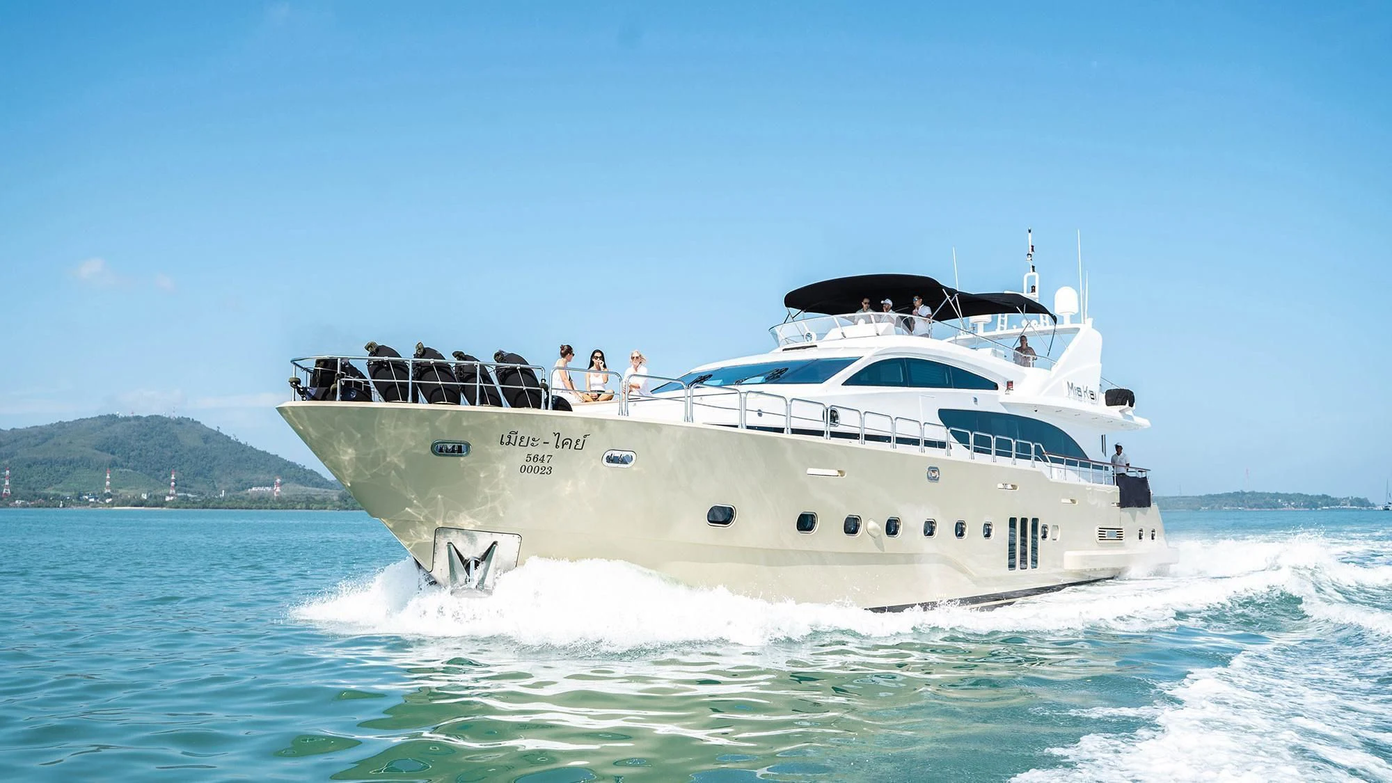 a white boat with people on it aboard MIA KAI Yacht for Charter