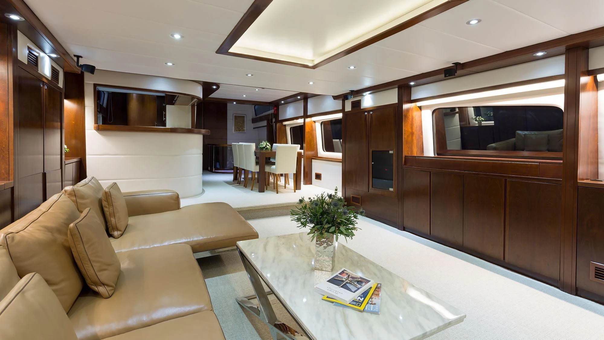 a living room with a couch and a coffee table aboard MIA KAI Yacht for Charter