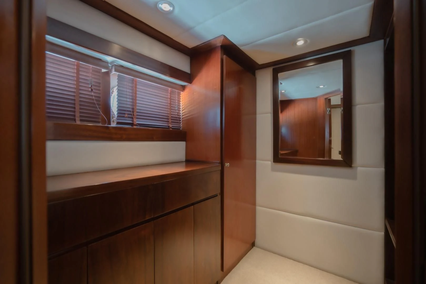 a room with a wood cabinet and a window aboard MIA KAI Yacht for Charter