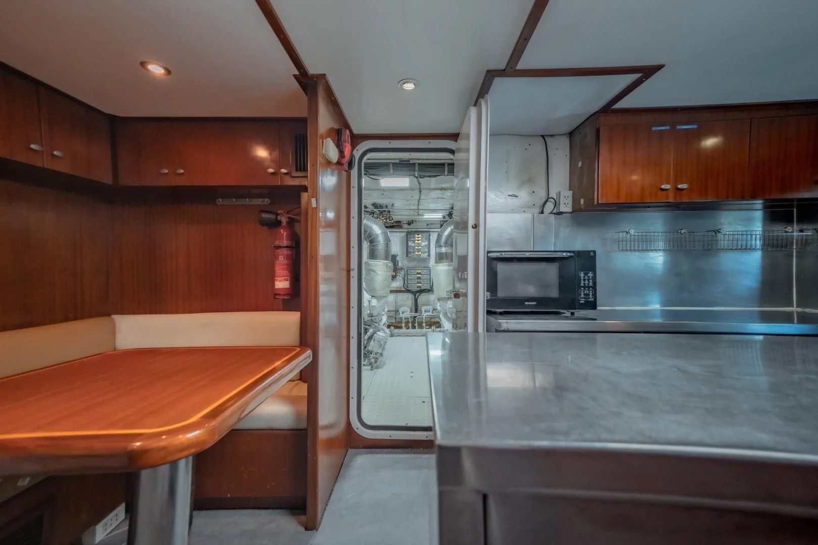 a kitchen with a table and a microwave aboard MIA KAI Yacht for Charter