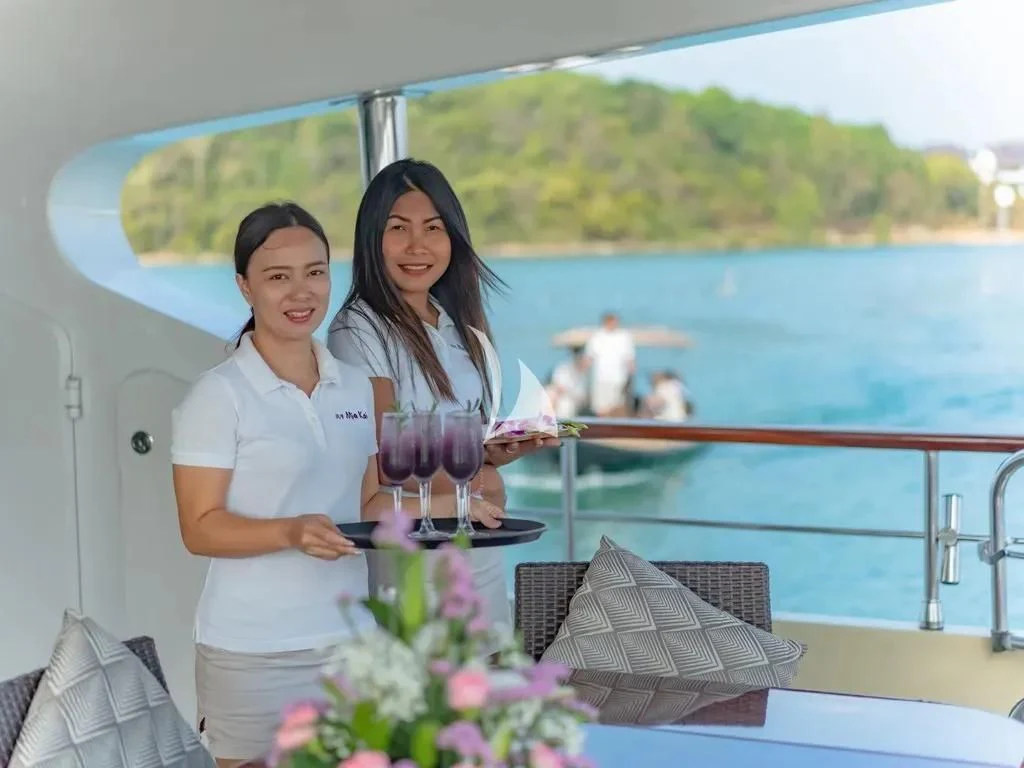a couple of women holding wine glasses aboard MIA KAI Yacht for Charter