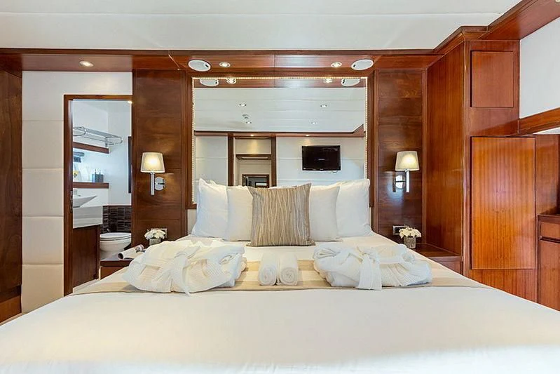 a bed with white sheets aboard MIA KAI Yacht for Charter