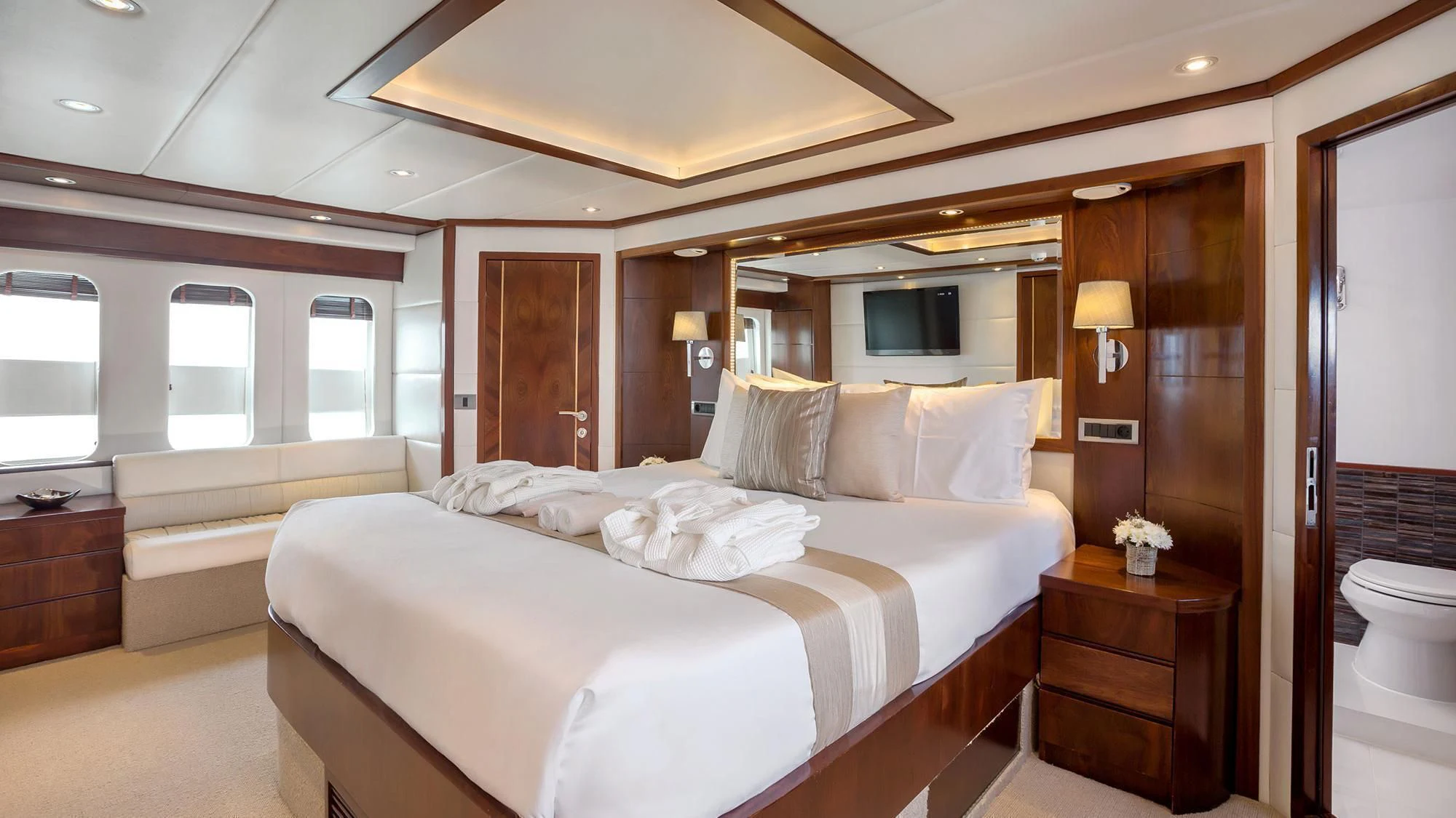 a large bedroom with a large bed aboard MIA KAI Yacht for Charter