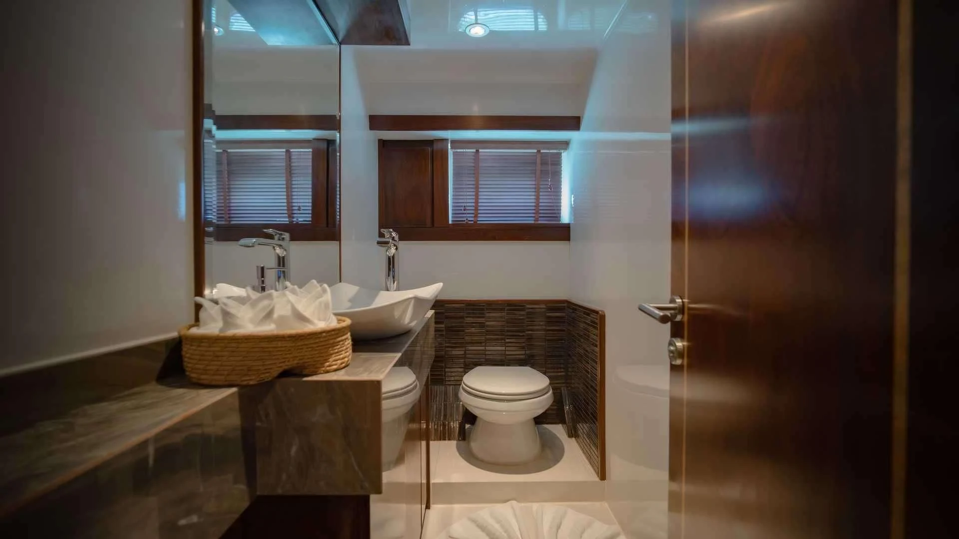 a bathroom with a sink toilet and a mirror aboard MIA KAI Yacht for Charter
