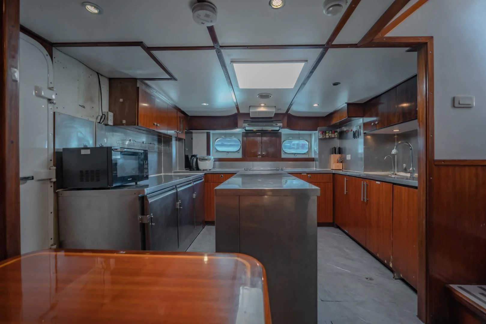 a kitchen with a counter and cabinets aboard MIA KAI Yacht for Charter