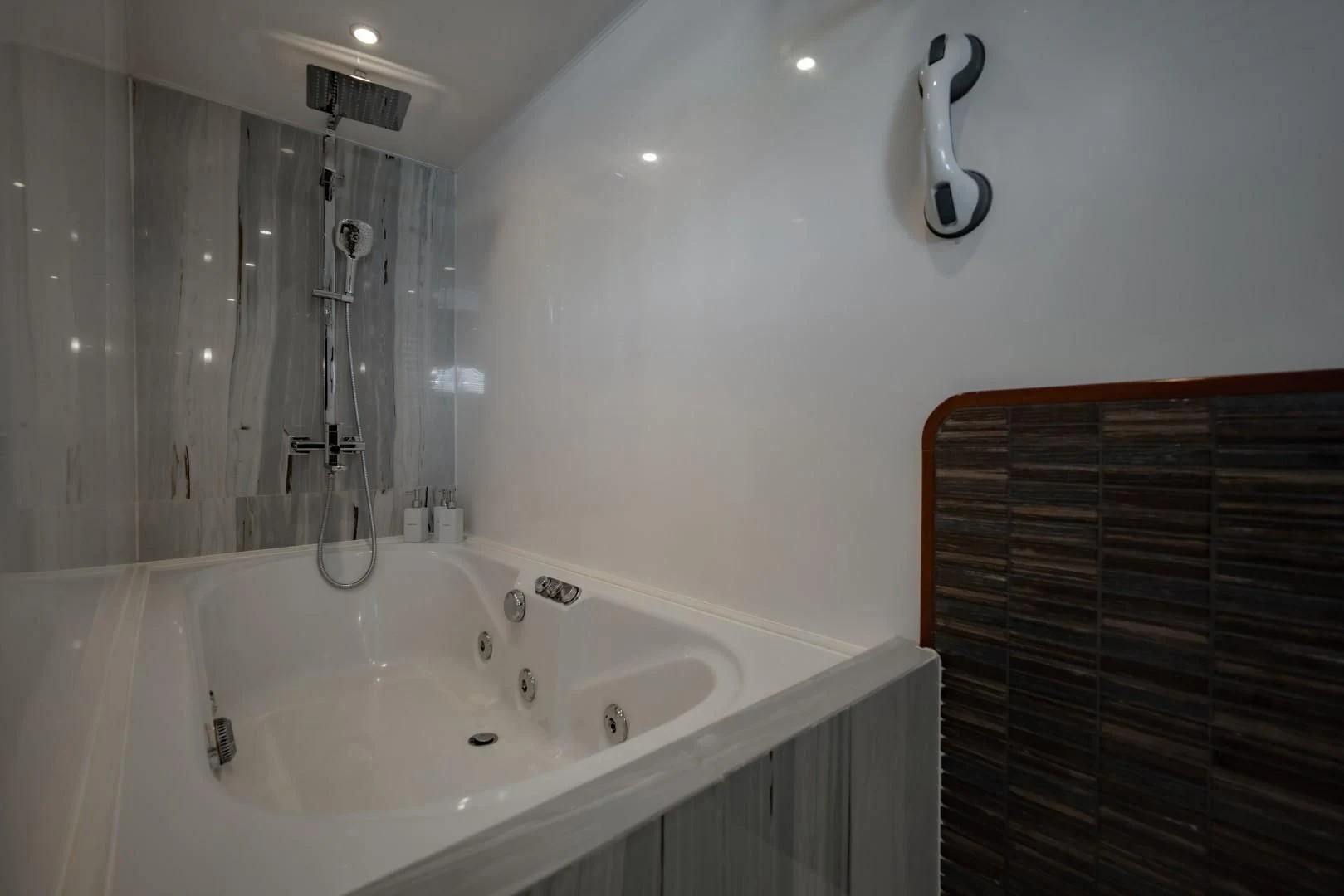 a bathtub with a shower head aboard MIA KAI Yacht for Charter