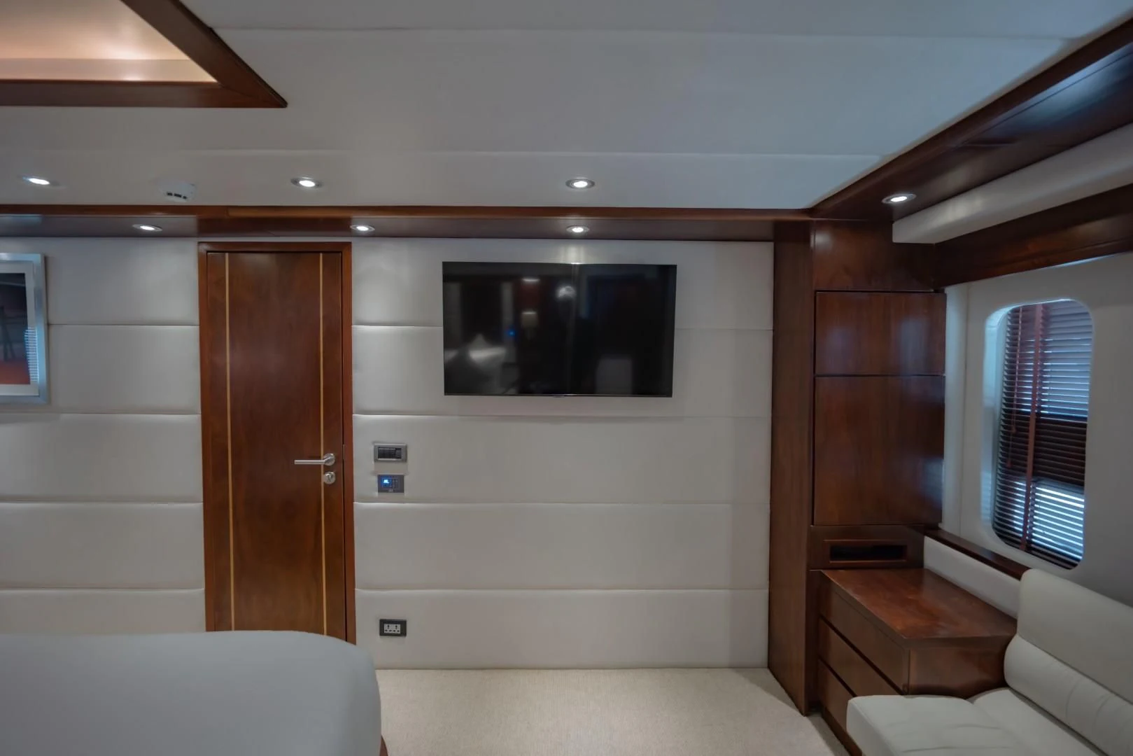 a room with a tv and a couch aboard MIA KAI Yacht for Charter