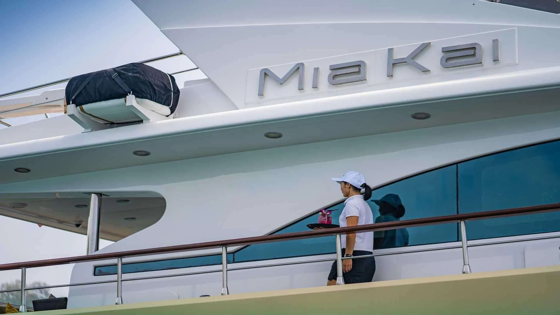 a person walking on a walkway aboard MIA KAI Yacht for Charter