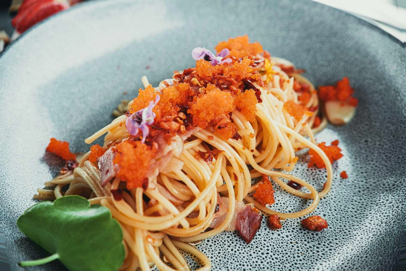 a bowl of noodles with sauce aboard MIA KAI Yacht for Charter