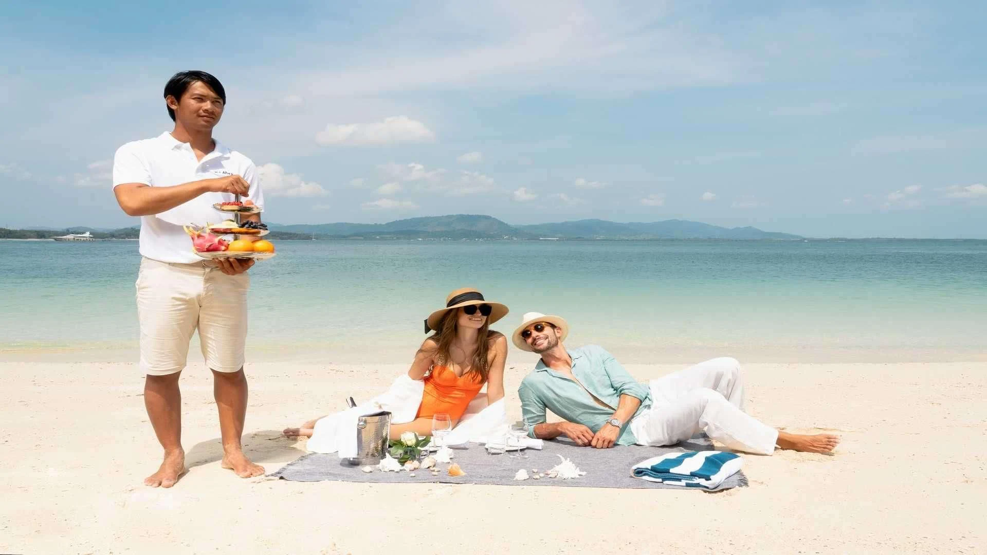 a man and woman on a beach aboard MIA KAI Yacht for Charter