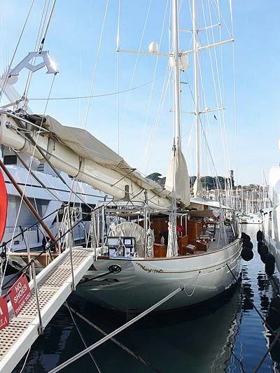 a large white boat in a harbor aboard ADELA Yacht for Sale