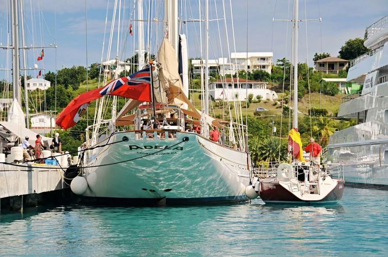 a sailboat with a flag on it aboard ADELA Yacht for Sale