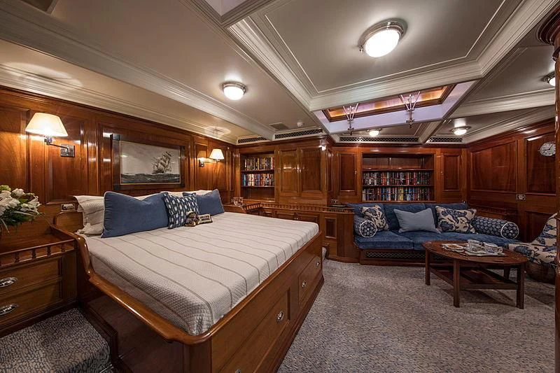 a bedroom with a bed and a couch aboard ADELA Yacht for Sale