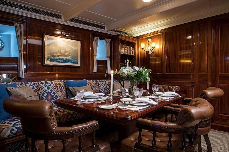 a dining room with a table and chairs aboard ADELA Yacht for Sale