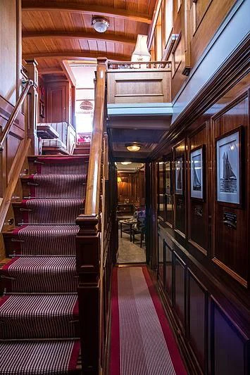 a hallway with a red carpet aboard ADELA Yacht for Sale
