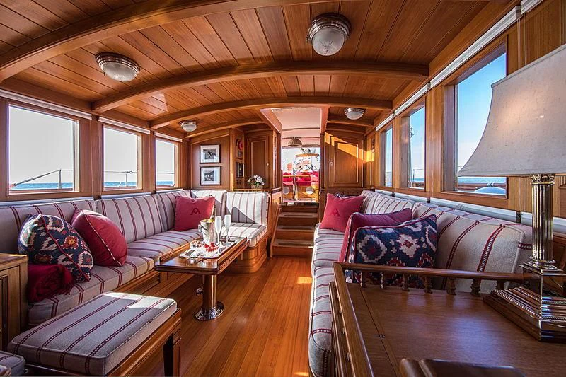 a living room with a couch and a coffee table aboard ADELA Yacht for Sale