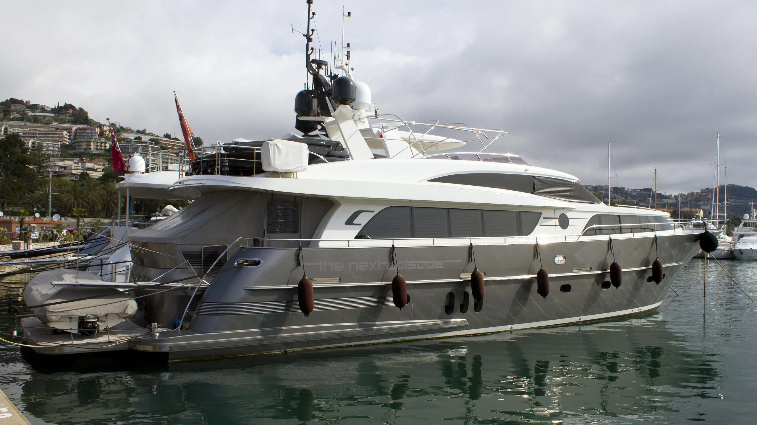 a white yacht in a harbor aboard O NOSO UNO Yacht for Sale