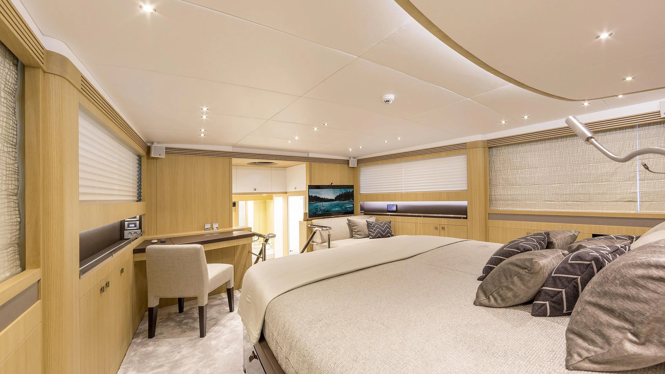 a bedroom with a bed and a desk aboard O NOSO UNO Yacht for Sale