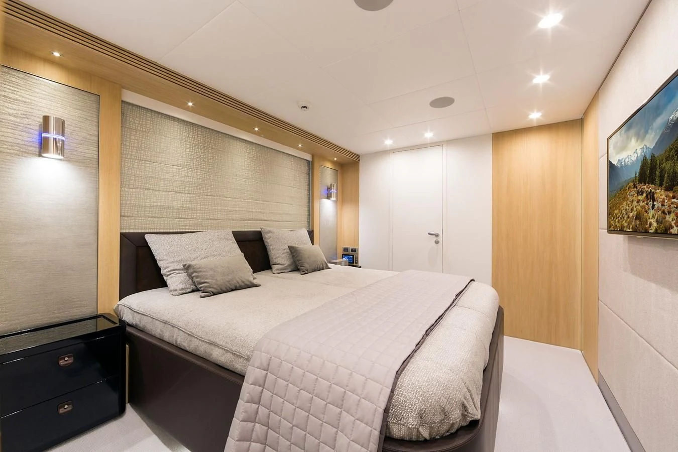 a bedroom with a bed and a desk aboard O NOSO UNO Yacht for Sale