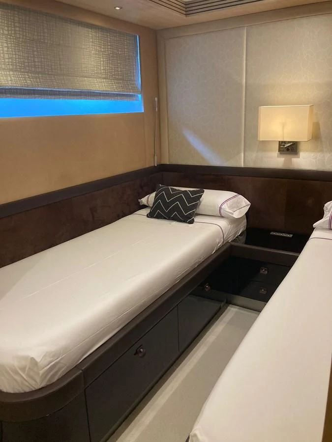 a bed with a pillow and a lamp on top of it aboard O NOSO UNO Yacht for Sale
