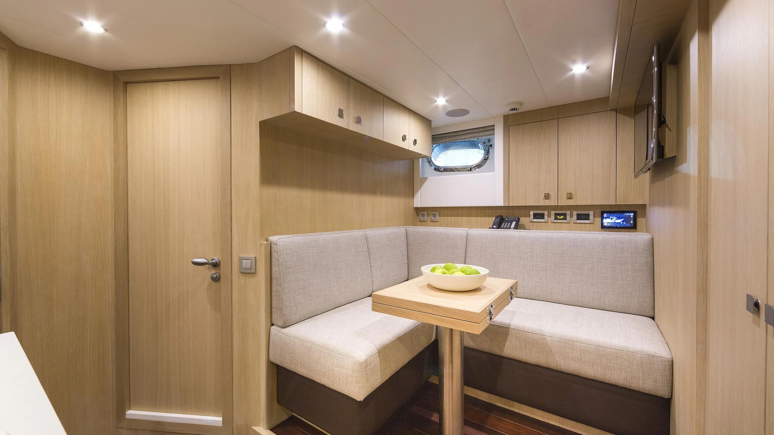 a room with a table and couch aboard O NOSO UNO Yacht for Sale