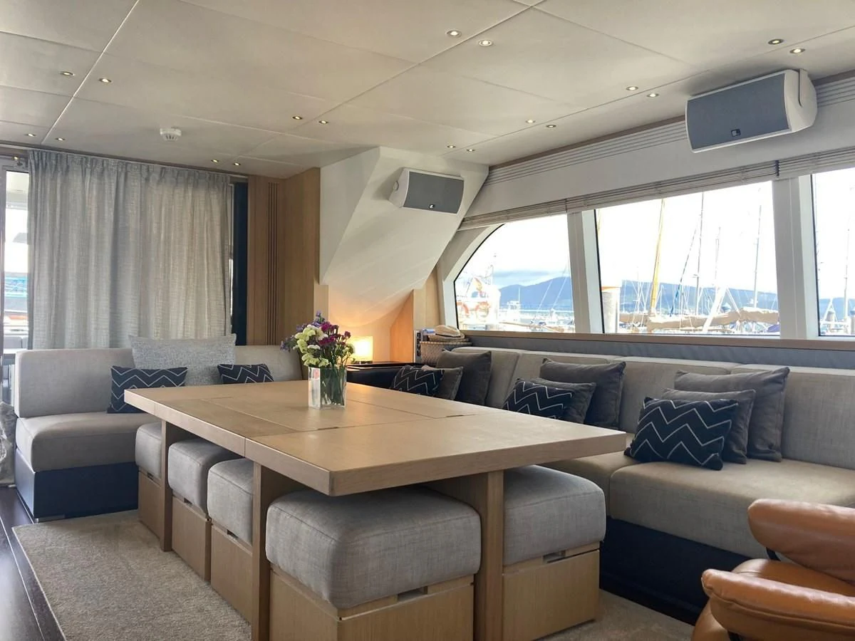 a living room with a couch and a table aboard O NOSO UNO Yacht for Sale