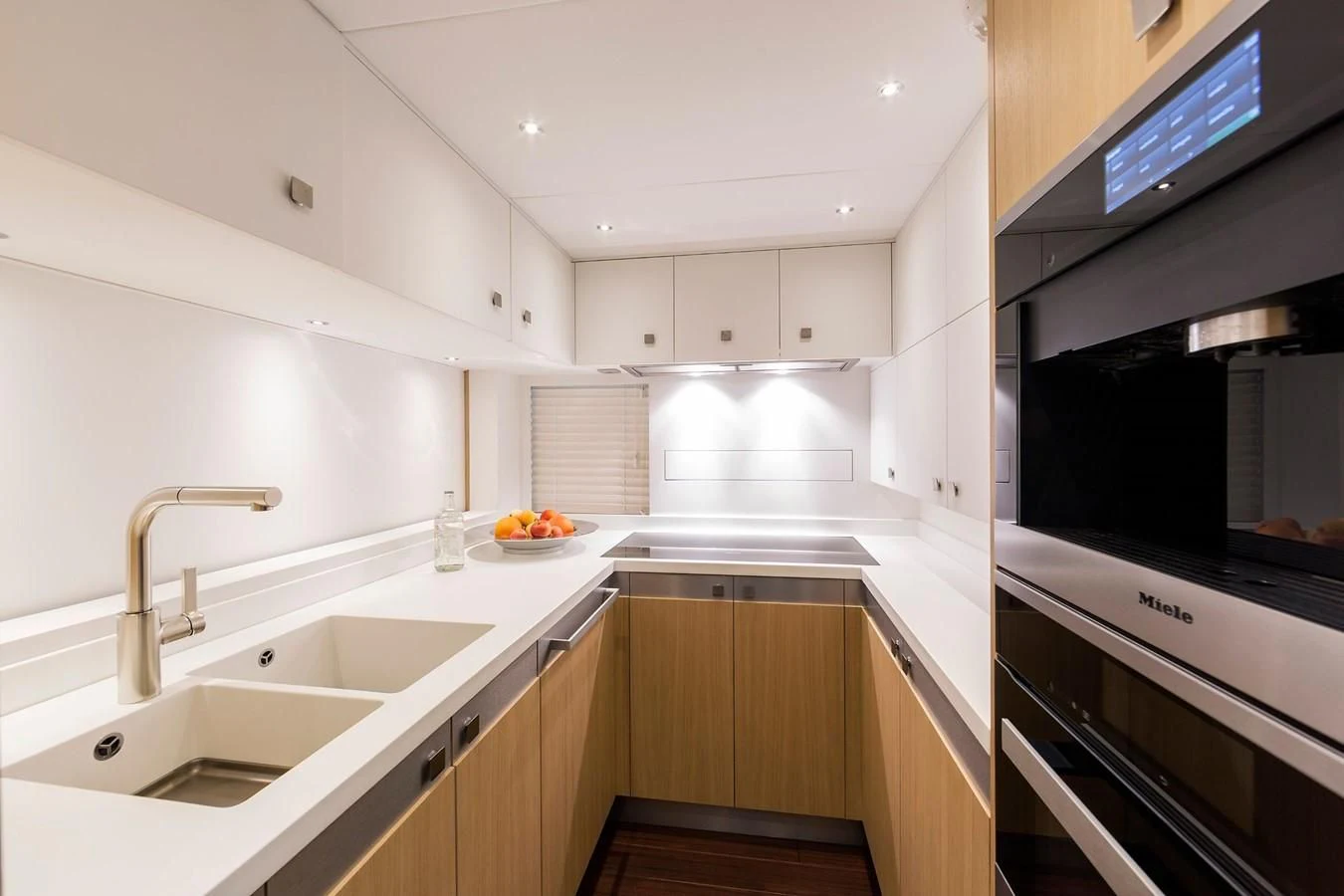 a kitchen with white cabinets aboard O NOSO UNO Yacht for Sale