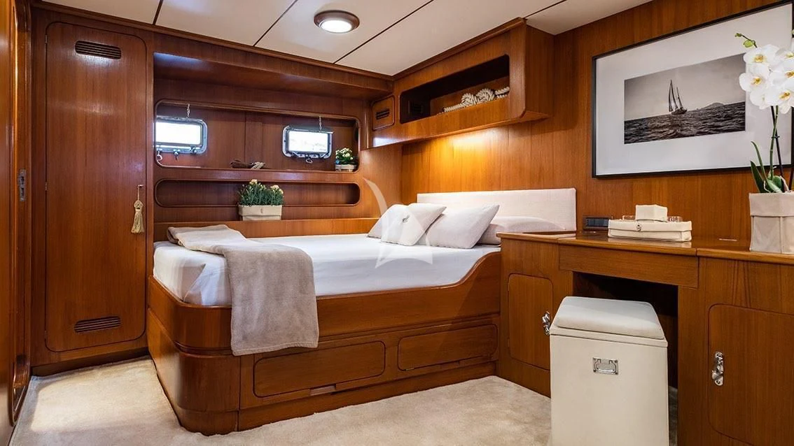 a room with a bed and a desk aboard LOTTY Yacht for Sale