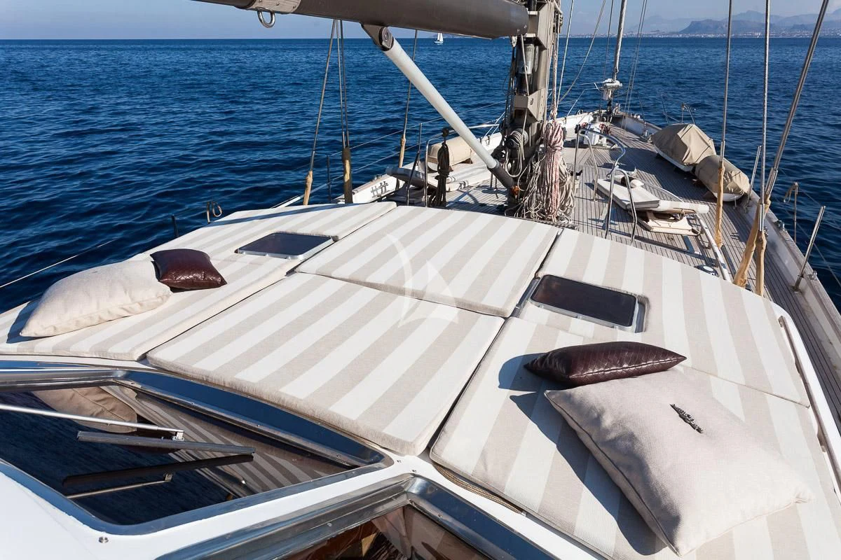a white boat with a brown object on the front aboard LOTTY Yacht for Sale