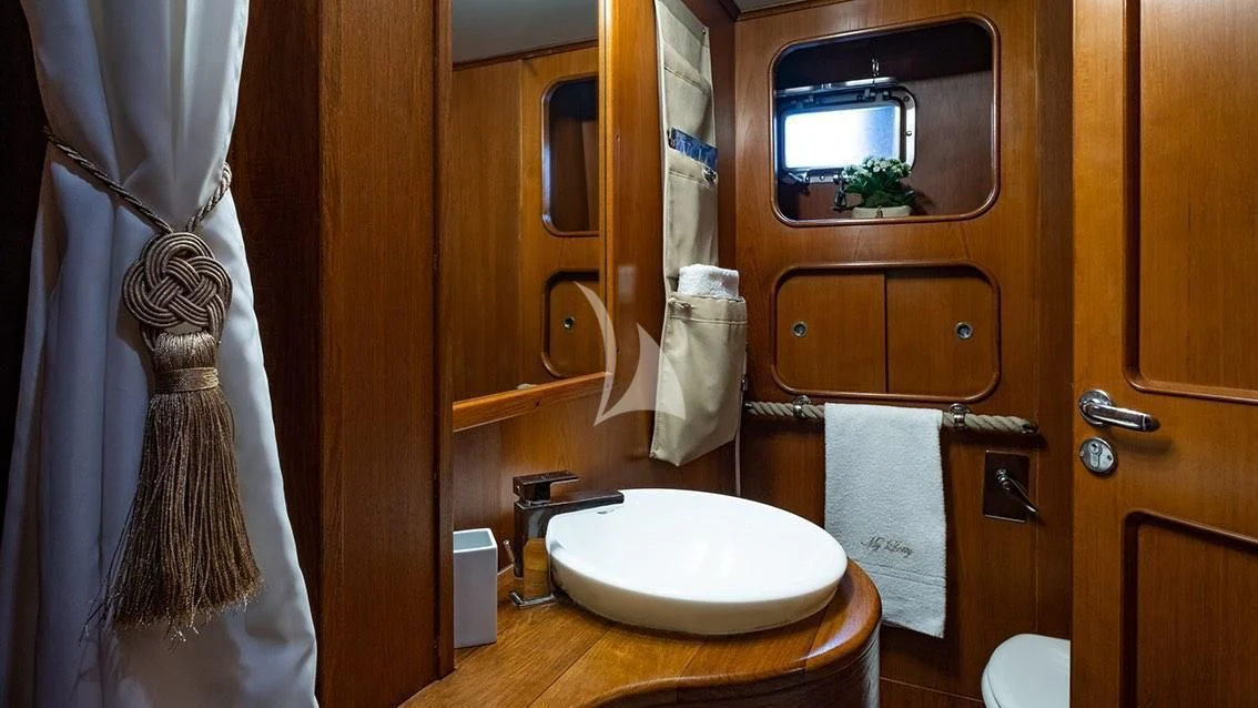 a bathroom with a toilet and a sink aboard LOTTY Yacht for Sale