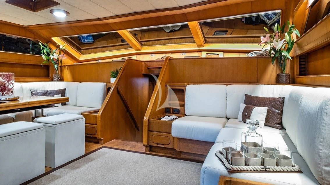 a living room with a couch and a table aboard LOTTY Yacht for Sale