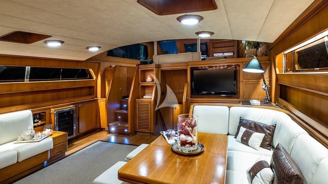 a living room with a fireplace aboard LOTTY Yacht for Sale