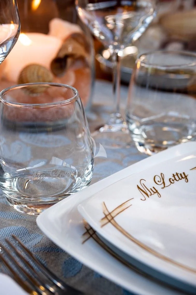 a table with empty glasses aboard LOTTY Yacht for Sale